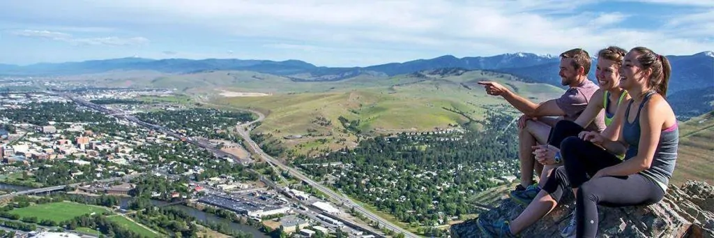 Hikers enjoy the view of Missoula from Mount Sentinel